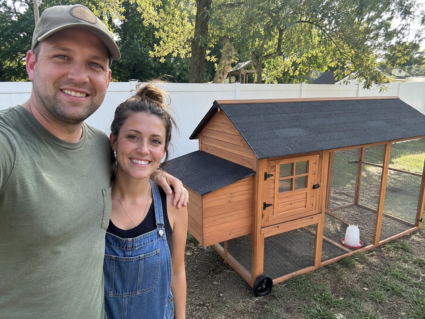 Couple next to their finished chicken coop